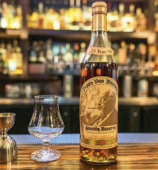 A bottle of whiskey sitting on top of a wooden table.