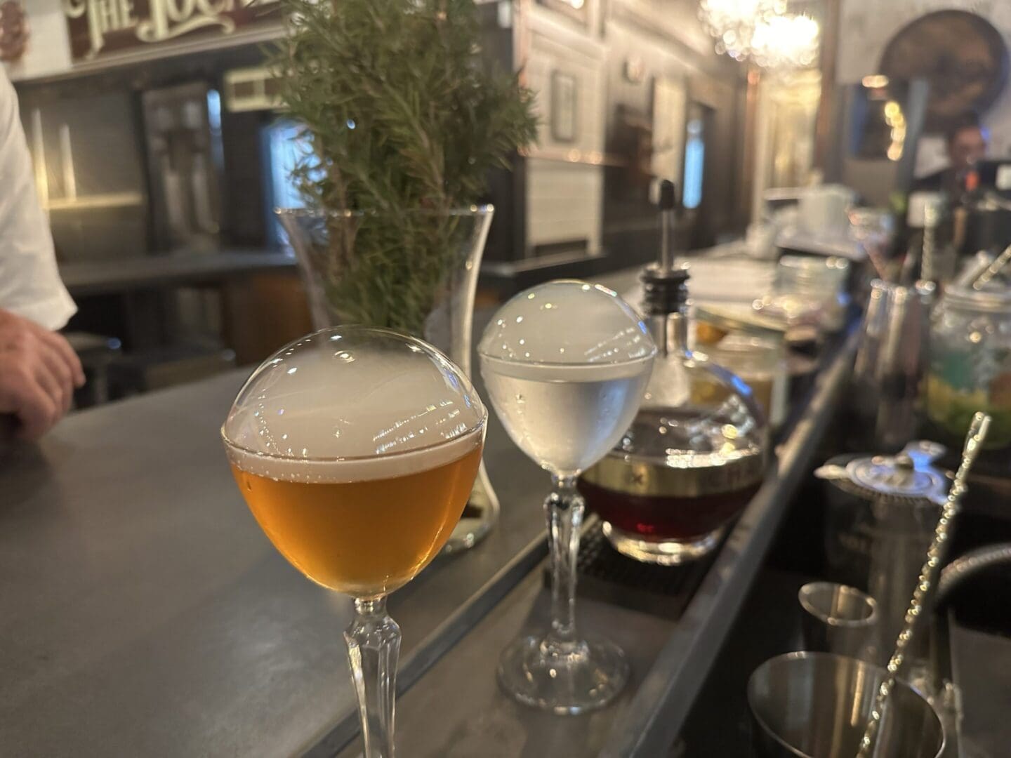 A bar with two glasses of wine and water.