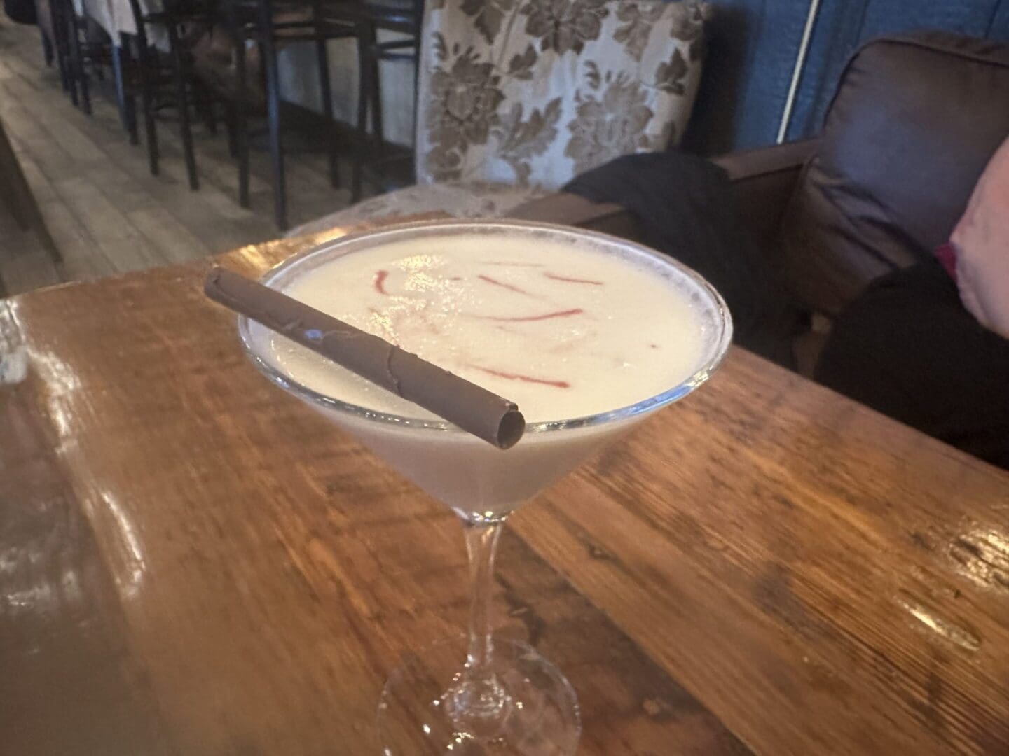 A martini glass with a cigar in it.