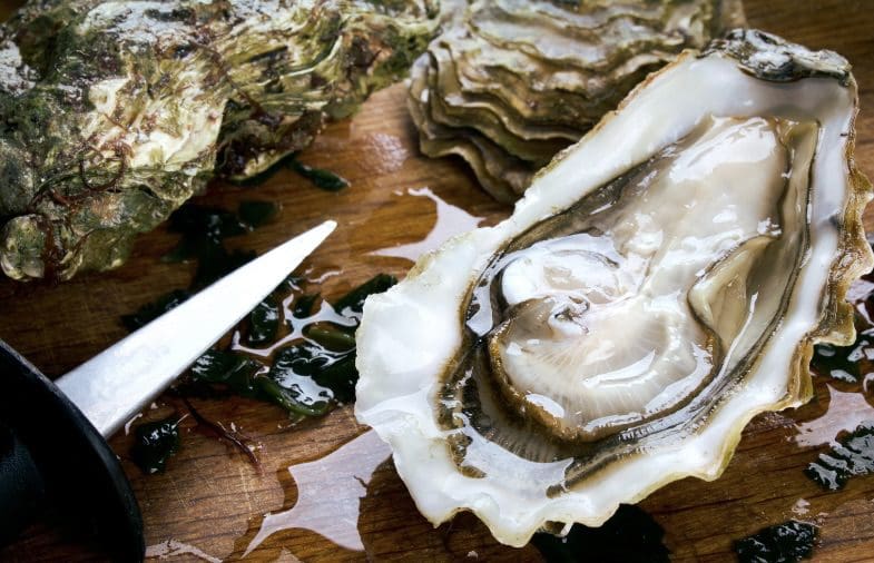 A close up of an opened oyster on the table