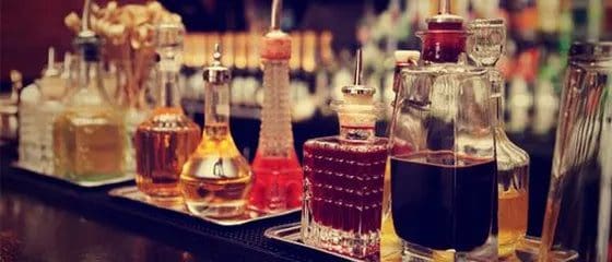 A table with several different bottles of alcohol.
