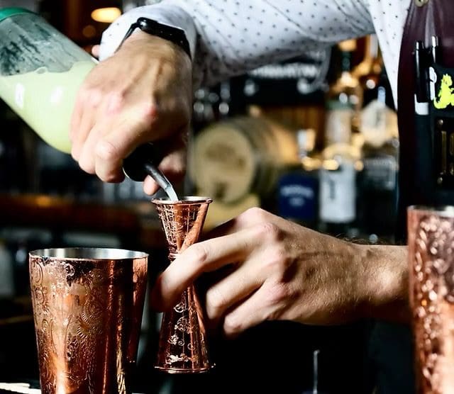 A person is pouring some liquid into a cup.