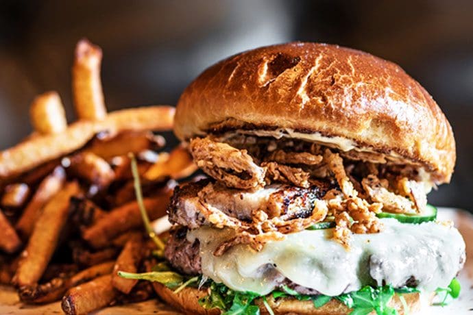 A close up of a burger and fries