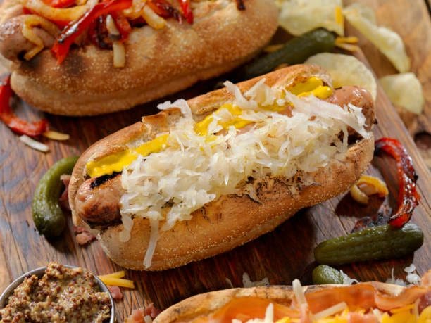 A close up of hot dogs on buns with toppings